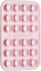 Chalk pink OCTOBUDDY phone mount attached to the back of a smartphone.